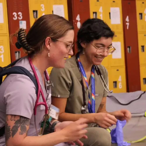 Two street medical providers sitting outside talking